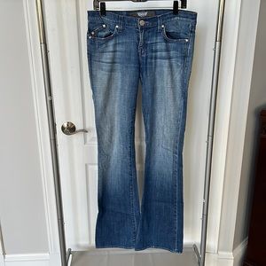 Medium wash flare jeans with purple embellishments